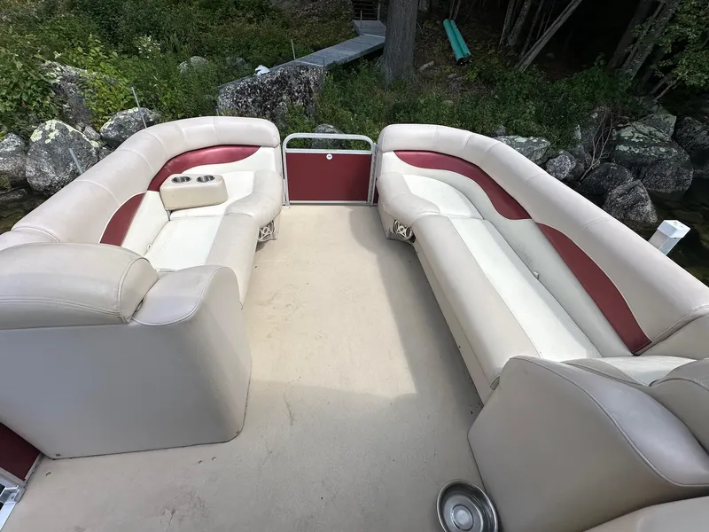 Slide: The Image of Interior of a 2012 Godfrey 2086 boat with beige and red seating. - 4