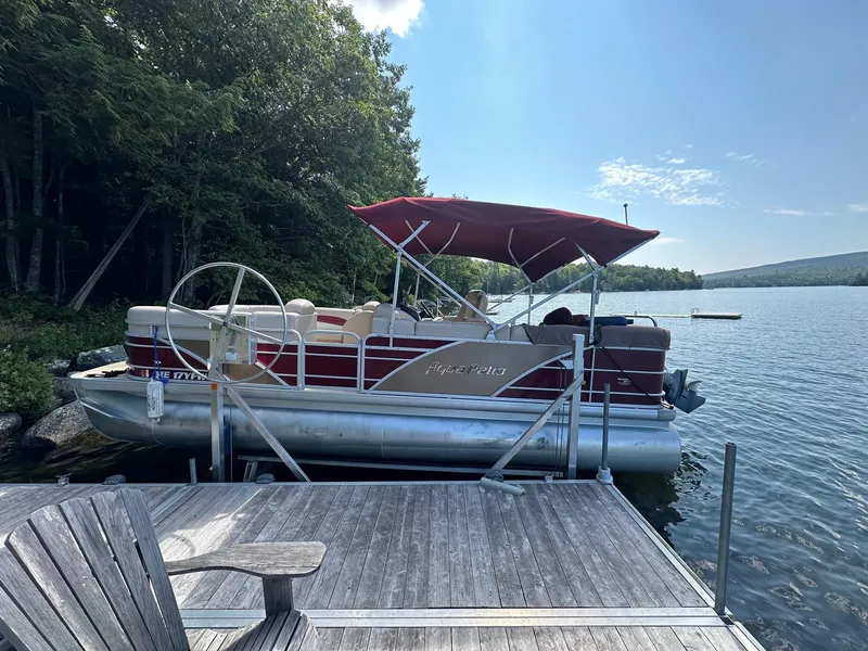 Slide: The Image of 2012 Godfrey 2086 pontoon boat docked on a serene lake. - 5