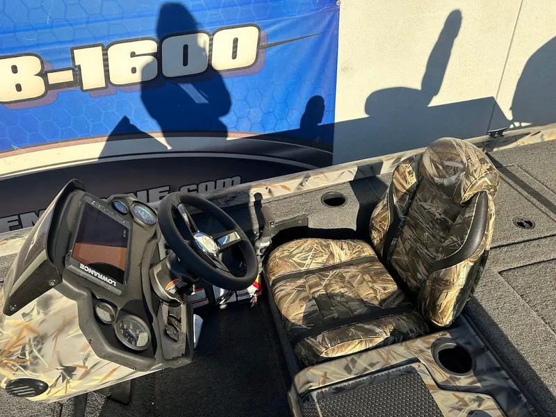 Slide: The Image of 2024 Ranger RT188P boat interior with camo seats and steering console. - 15