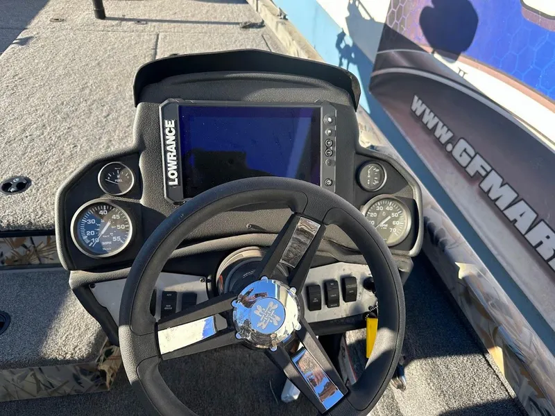 Slide: The Image of 2024 Ranger RT188P boat dashboard with Lowrance display and steering wheel. - 16