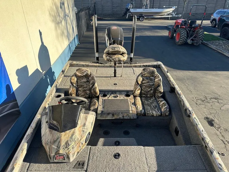 Slide: The Image of 2024 Ranger RT188P fishing boat with camo seats and steering wheel. - 25