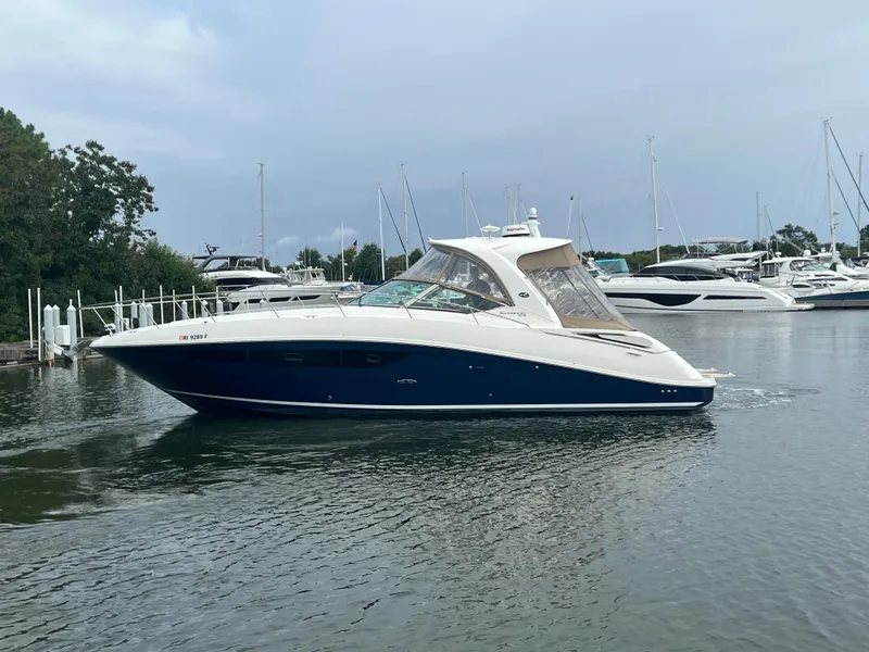 Slide: The Image of 2016 Sea Ray 370 Sundancer yacht docked in a marina. - 12