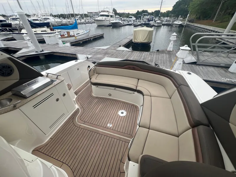 Slide: The Image of 2016 Sea Ray 370 Sundancer yacht with spacious seating at marina dock. - 14