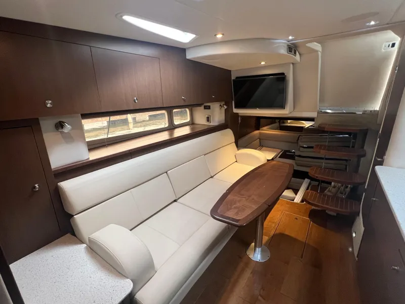 Slide: The Image of Luxurious interior of 2016 Sea Ray 370 Sundancer yacht with modern seating and entertainment area. - 20