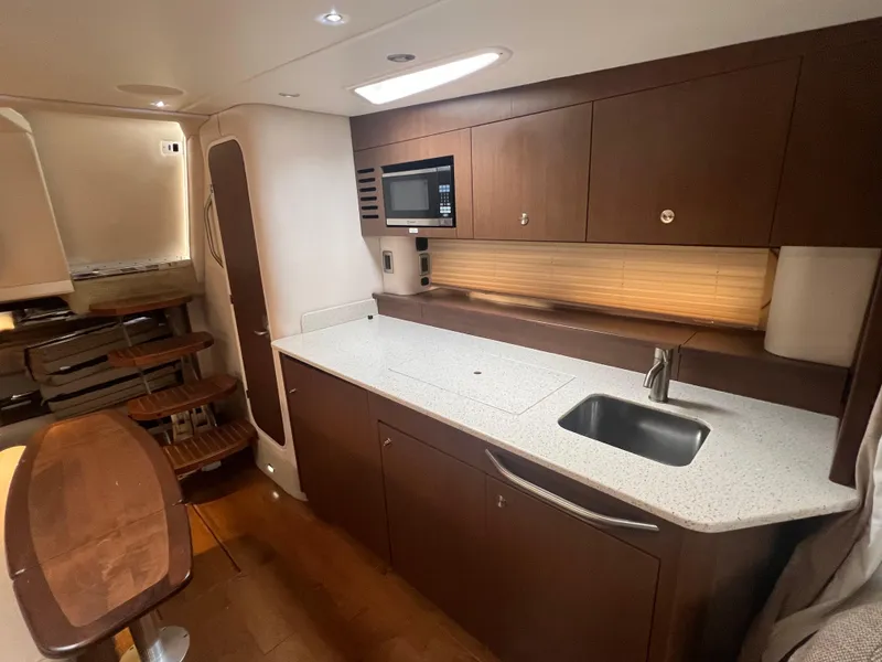 Slide: The Image of Luxurious 2016 Sea Ray 370 Sundancer yacht interior kitchen with modern amenities. - 21