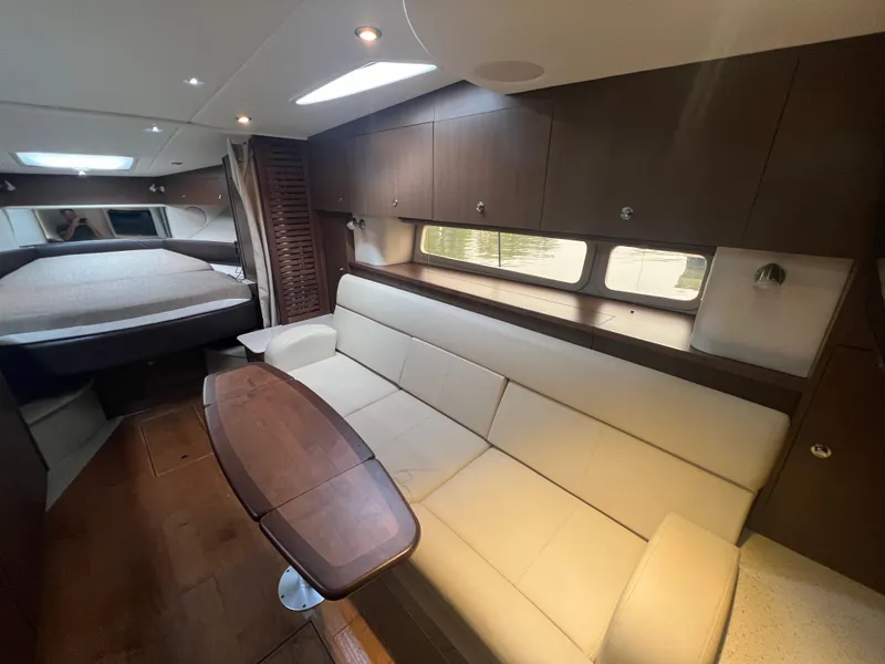 Slide: The Image of Luxurious interior of 2016 Sea Ray 370 Sundancer yacht with sofa and table. - 22