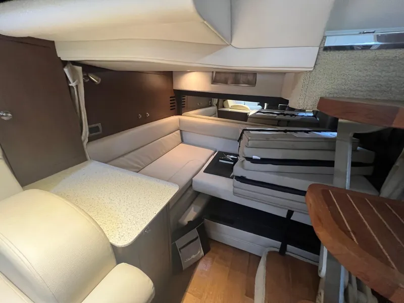 Slide: The Image of Interior of 2016 Sea Ray 370 Sundancer yacht with modern seating and wood accents. - 25