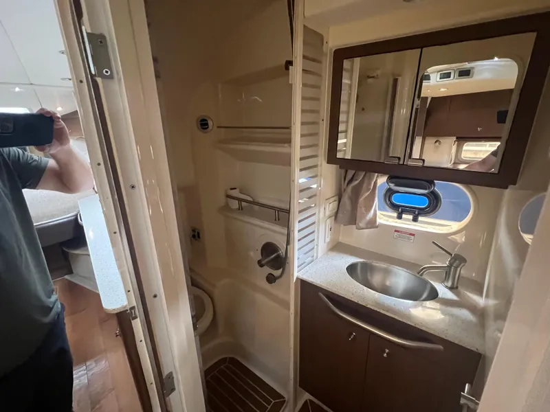 Slide: The Image of Interior of 2016 Sea Ray 370 Sundancer bathroom with sink, mirror, and shower. - 26