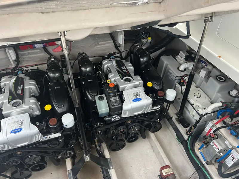Slide: The Image of Engine compartment of 2016 Sea Ray 370 Sundancer with dual engines and mechanical components. - 28