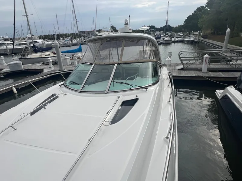 Slide: The Image of 2016 Sea Ray 370 Sundancer yacht docked at marina, overcast sky. - 29