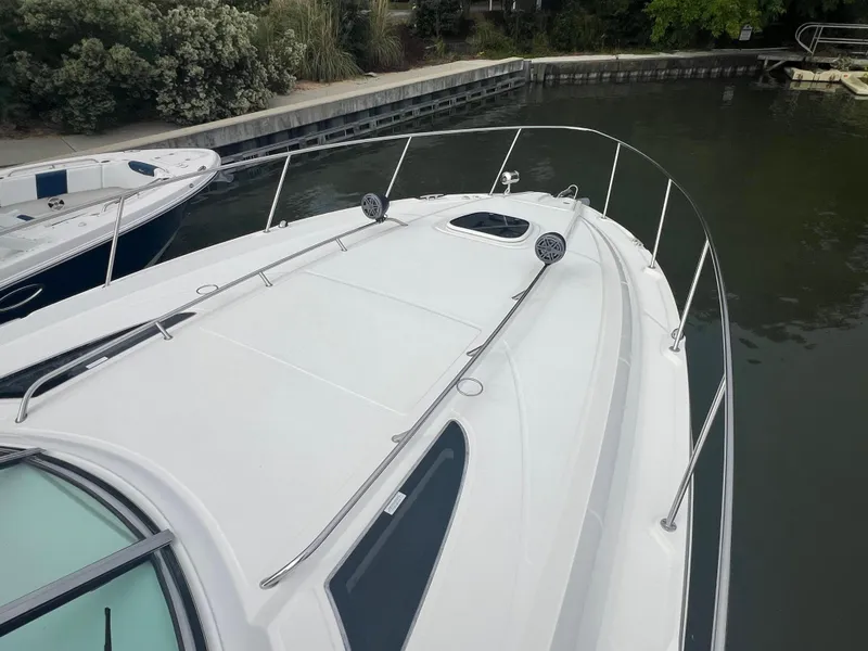 Slide: The Image of 2016 Sea Ray 370 Sundancer docked, showcasing sleek design and spacious deck. - 35