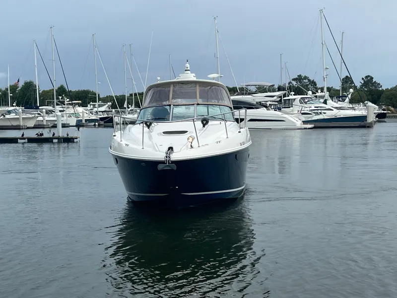 Slide: The Image of 2016 Sea Ray 370 Sundancer yacht docked in marina, surrounded by other boats. - 6