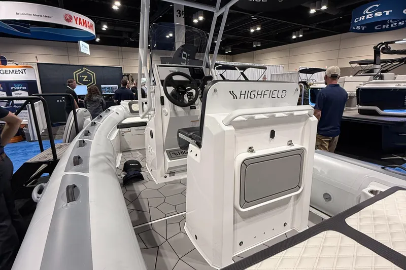 Slide: The Image of 2025 Highfield Sport 560 boat displayed at an indoor exhibition. - 10