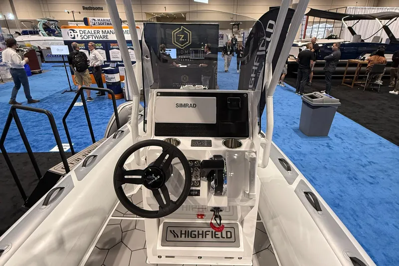 Slide: The Image of Highfield Sport 560 boat dashboard, 2025 model, featuring Simrad navigation system at a boat show. - 14