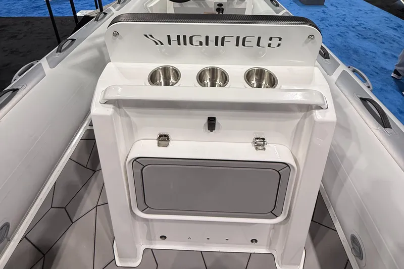 Slide: The Image of 2025 Highfield Sport 560 boat console with cup holders and storage compartment. - 18