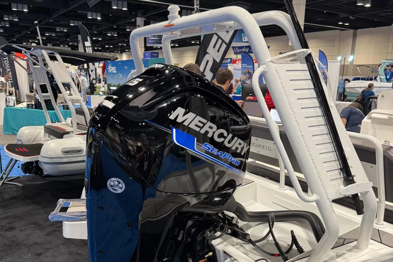 Slide: The Image of Highfield Sport 560 boat with Mercury engine at a 2025 boat show. - 4