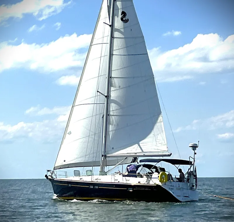 Slide: The Image of Sailing yacht Beneteau 411, 2002 model, cruising on open water under clear skies. - 23