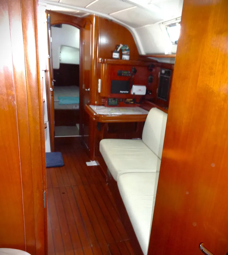 Slide: The Image of Interior of 2002 Beneteau 411 sailboat with wooden finish and seating area. - 5