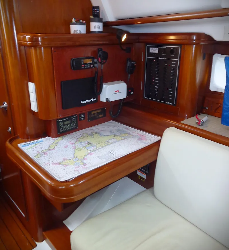 Slide: The Image of Navigation station in a 2002 Beneteau 411 sailboat with chart and communication equipment. - 6
