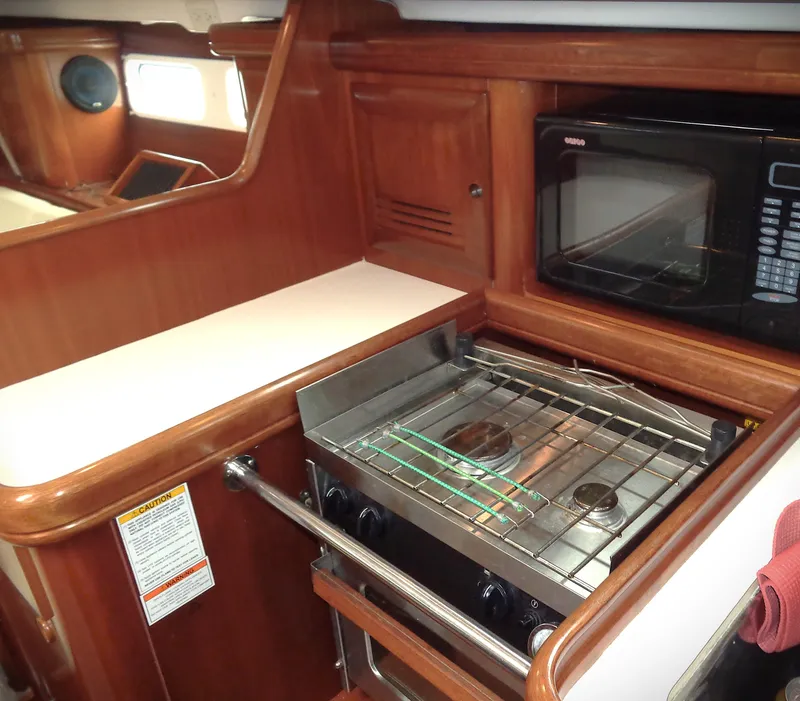 Slide: The Image of Interior of 2002 Beneteau 411 yacht kitchen with stove and microwave. - 9