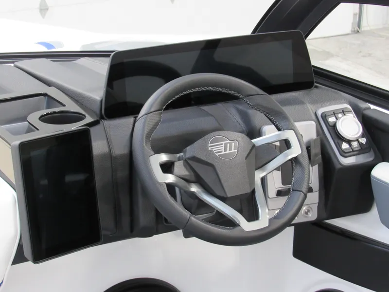 Slide: The Image of 2025 Malibu Wakesetter 22 LSV dashboard with modern steering wheel and digital controls. - 7
