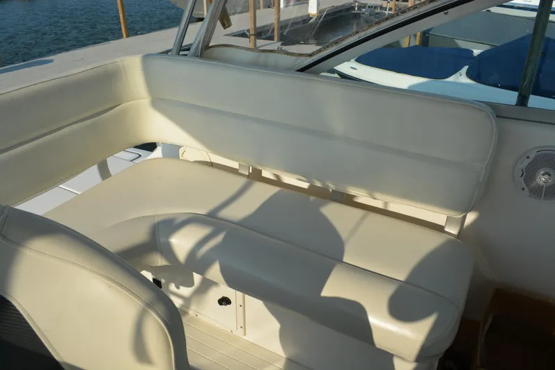 Slide: The Image of 1999 Pursuit 3400 Express boat interior with white leather seating and speaker. - 11
