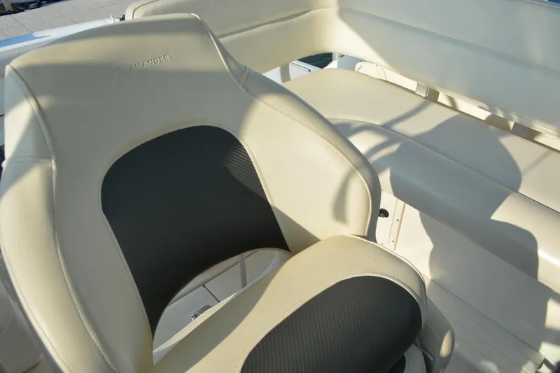 Slide: The Image of 1999 Pursuit 3400 Express boat seating with beige and black upholstery. - 12