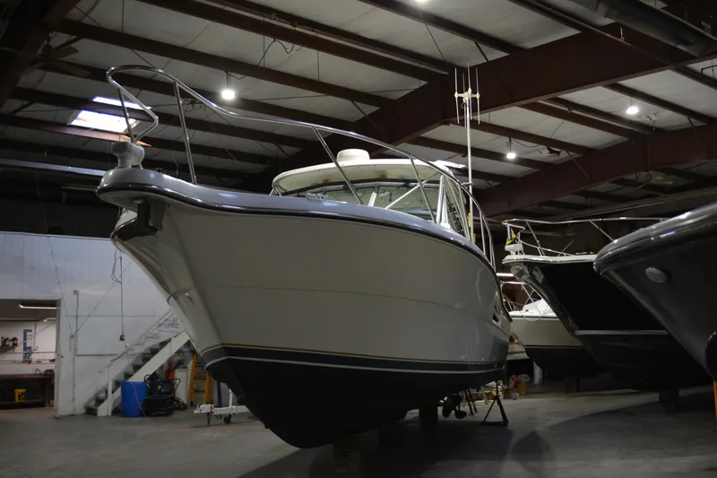 Slide: The Image of 1999 Pursuit 3400 Express boat in indoor storage facility. - 14