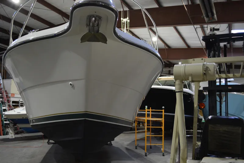 Slide: The Image of 1999 Pursuit 3400 Express boat in indoor storage facility. - 17