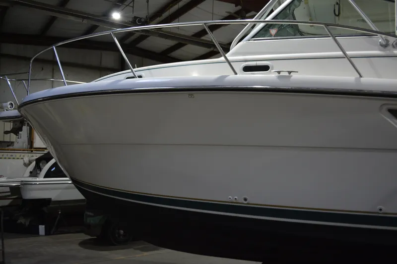 Slide: The Image of 1999 Pursuit 3400 Express boat in indoor storage facility. - 21