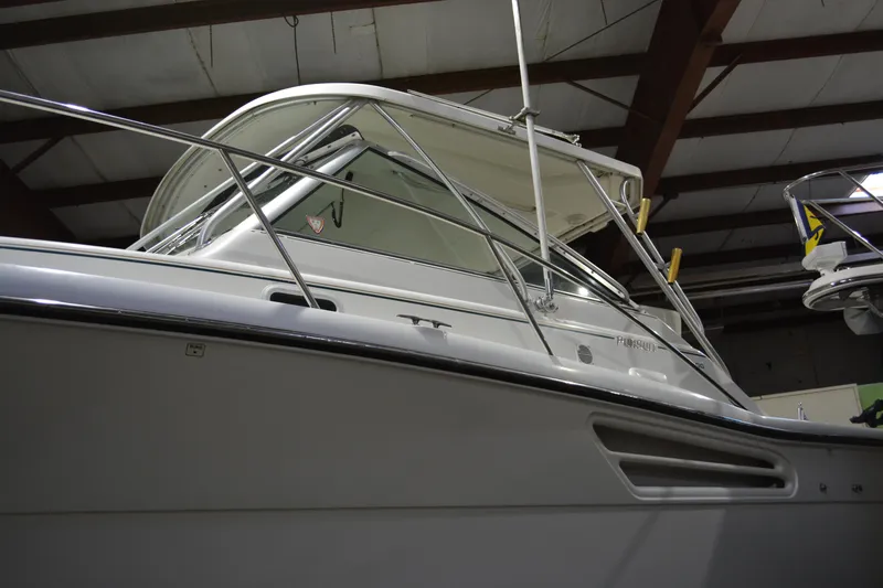 Slide: The Image of 1999 Pursuit 3400 Express boat in indoor storage facility. - 23