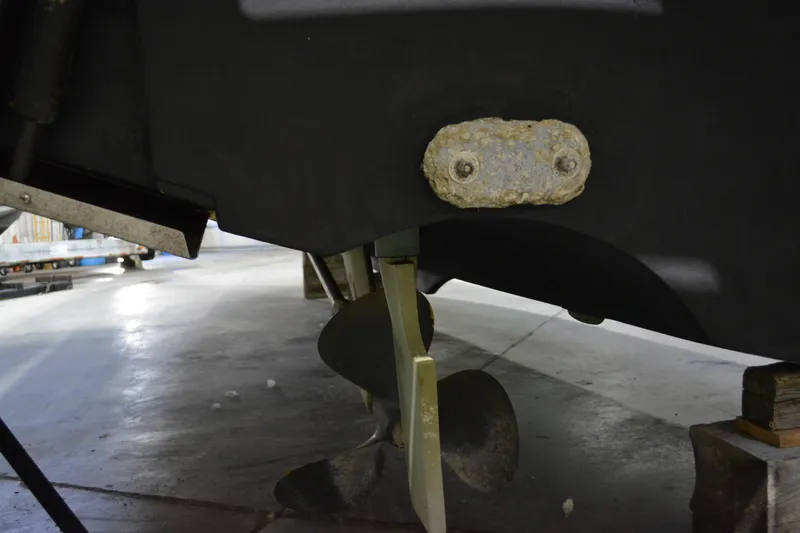 Slide: The Image of Close-up of 1999 Pursuit 3400 Express boat propeller and hull in a garage. - 25