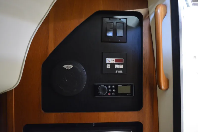 Slide: The Image of Interior of 1999 Pursuit 3400 Express with wooden flooring and beige seating. - 27