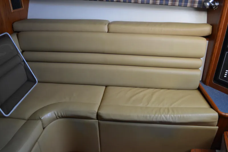 Slide: The Image of 1999 Pursuit 3400 Express interior with beige leather seating and control panel. - 33