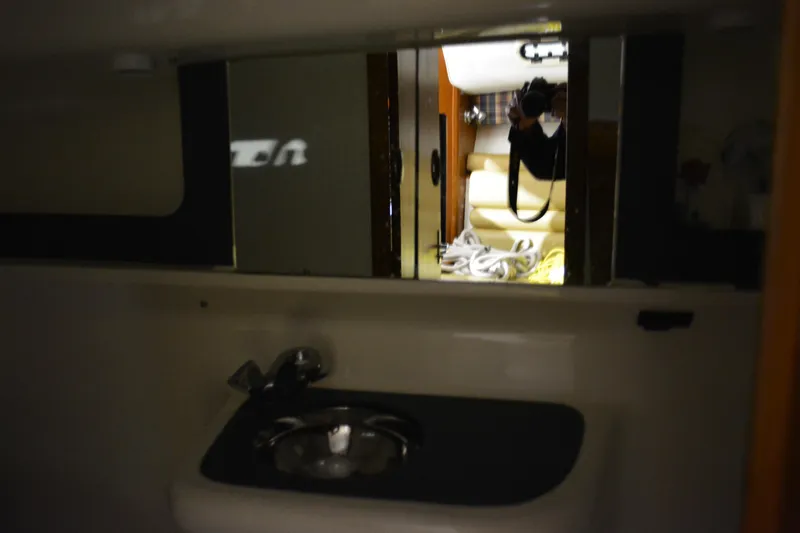 Slide: The Image of Interior of 1999 Pursuit 3400 Express yacht with wooden steps and cabinetry. - 35