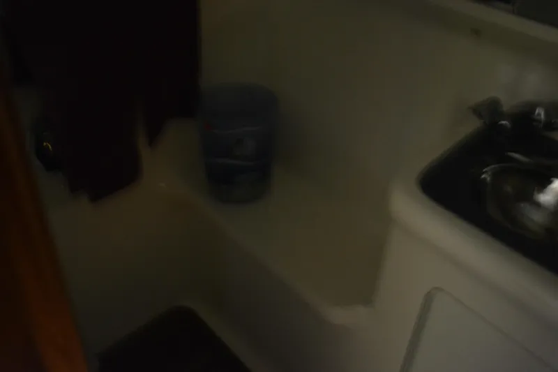 Slide: The Image of Interior of 1999 Pursuit 3400 Express boat with wooden cabinetry and blue accents. - 36