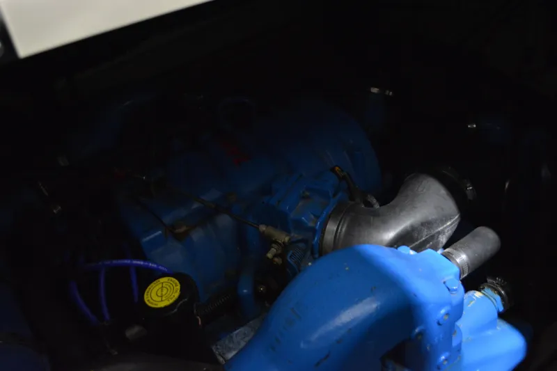 Slide: The Image of Interior of 1999 Pursuit 3400 Express boat with beige seating and plaid accents. - 39