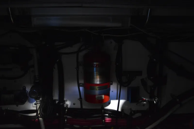 Slide: The Image of 1999 Pursuit 3400 Express interior with wooden cabinetry and nautical-themed rug. - 40