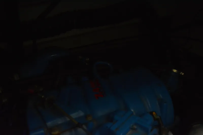 Slide: The Image of Cozy cabin interior of 1999 Pursuit 3400 Express with plaid bedding and decorative pillows. - 41