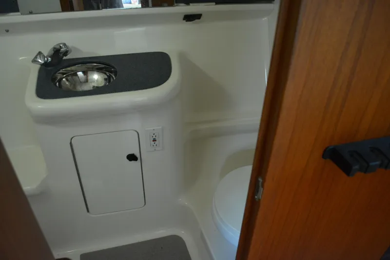Slide: The Image of 1999 Pursuit 3400 Express boat bathroom with sink and toilet. - 43