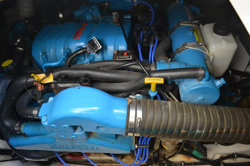 Slide: The Image of Engine compartment of a 1999 Pursuit 3400 Express boat, featuring blue components. - 50