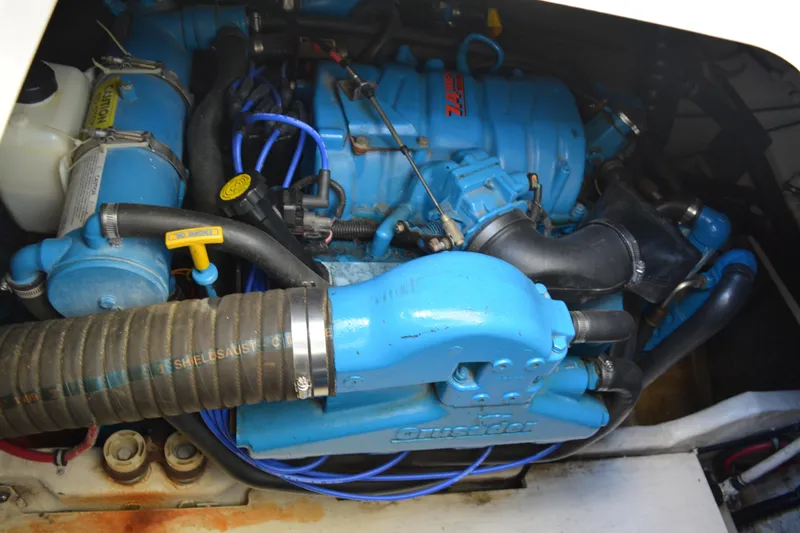 Slide: The Image of Engine compartment of a 1999 Pursuit 3400 Express boat, featuring blue components. - 51