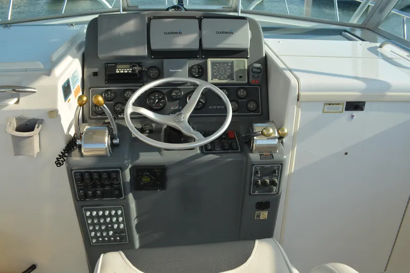 Slide: The Image of 1999 Pursuit 3400 Express helm with Garmin navigation and control panel. - 7