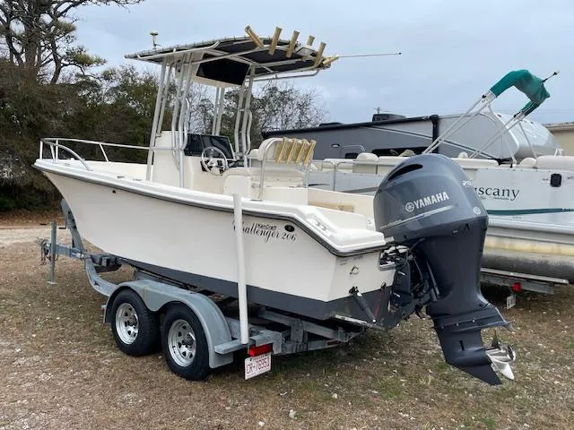 Slide: The Image of 2005 KenCraft 206 boat with Yamaha outboard motor on a trailer, parked outdoors. - 1