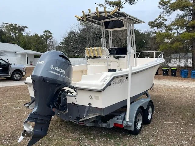 Slide: The Image of 2005 KenCraft 206 boat with T-top frame, docked in a marina under clear skies. - 2