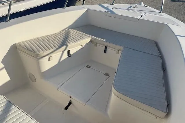 Slide: The Image of 2005 KenCraft 206 boat interior with cushioned seating and storage compartments. - 8