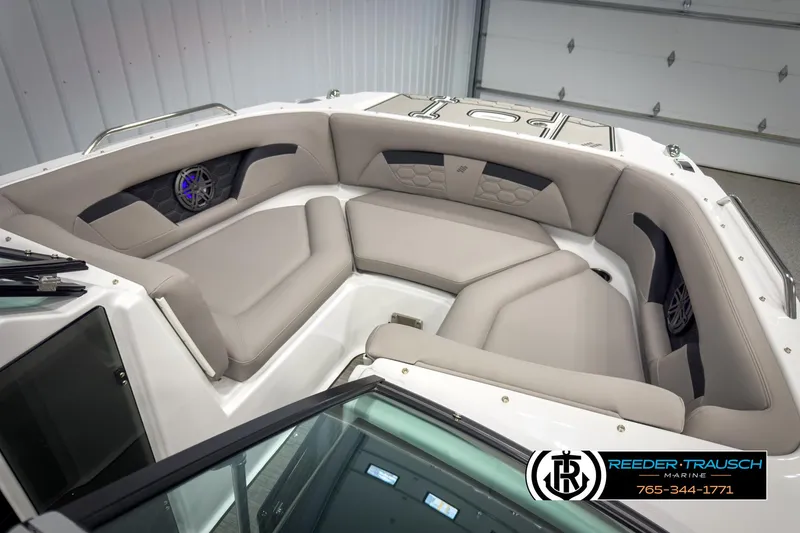 Slide: The Image of 2025 Four Winns HD3 boat interior with beige seating and speaker system. - 20