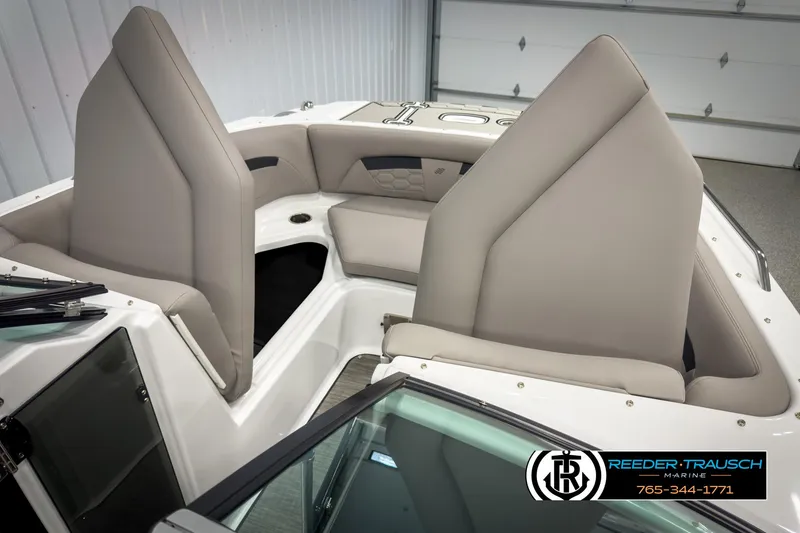 Slide: The Image of 2025 Four Winns HD3 boat interior with beige seating, showcased by Reeder-Trausch Marine. - 22