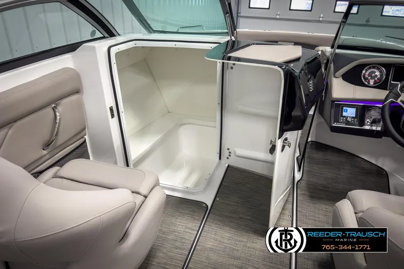 Slide: The Image of 2025 Four Winns HD3 boat interior with seating, storage, and control panel. - 28