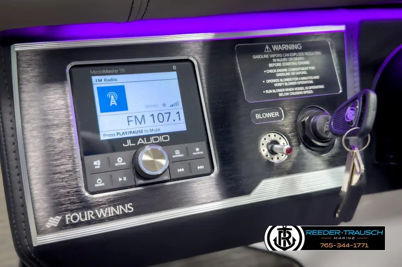 Slide: The Image of Control panel of 2025 Four Winns HD3 boat with JL Audio system and ignition keys. - 32